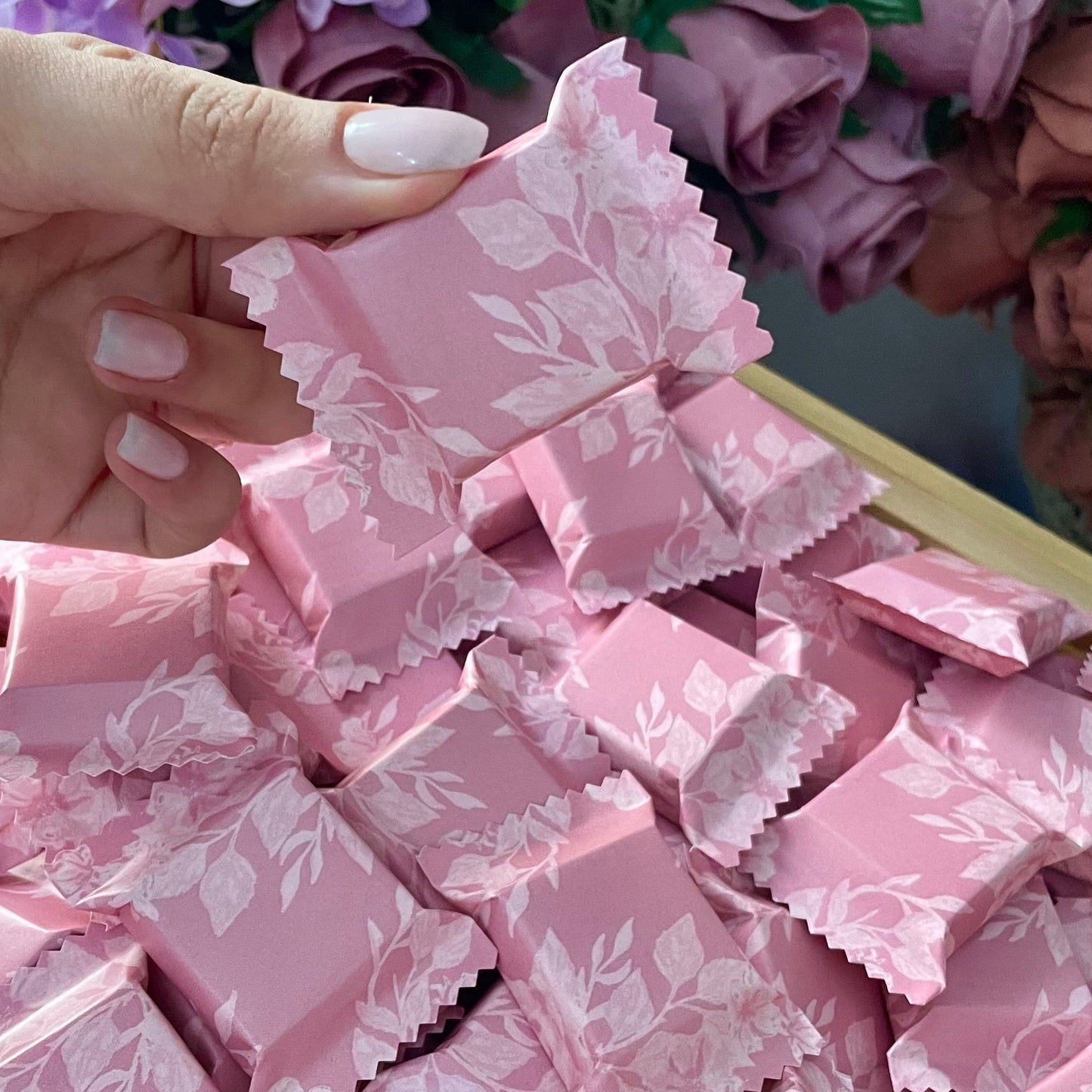 Délicats chocolats enveloppés dans un joli papier fleuri